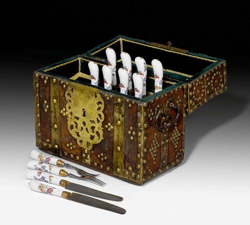 TRAVEL CUTLERY WITH CONTEMPORARY CUTLERY BOX, the porcelain Meissen, circa 1738-40. With leather-covered wooden cutlery box with brass rivets and mounts, the lock plate engraved with acanthus leaf and floral decoration, dated 1732. 6 forks and knives with 'Bienen' decoration, East Asian flowers, butterflies and bees.27.2x 30.5x 15cm. Key later supplemented.