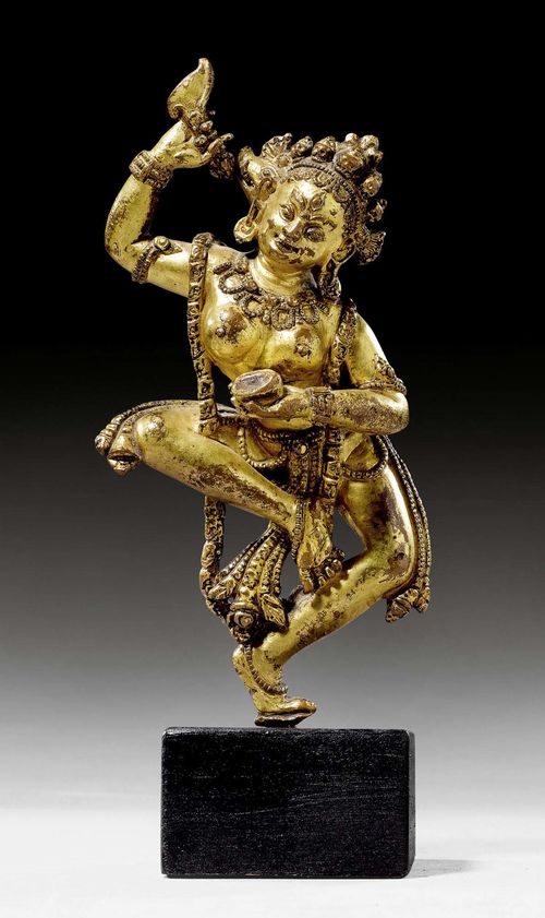 A GILT COPPER ALLOY FIGURE OF THE DANCING DAKINI VAJRAVARAHI. Nepalese work in Tibet, 14th c. Height 14 cm. Lotus base lost.