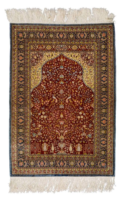 HEREKE SILK, PRAYER.Fineness: 14x14 knots/cm2. Red mihrab with beige spandrels, finely patterned with plant motifs and animals in delicate pastel colours, blue border with blossoms and palmettes, 93x133cm.