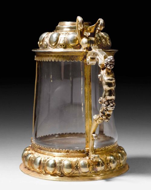 SILVER-GILT TANKARD, Zurich dated 1635. Maker&#39;s mark: Hans Heinrich M&#252;ller. Reverse glass painting depicting the year 1635 and inscribed &quot;Johannes Ziegler und Barbara H&#252;ettelin von Constanz sein Ehgem&#228;hel&quot;. Hinged cover. Rear glass conus missing, glass vessel later. With case. 19.5 cm, 785g. Provenance: Private collection, Zurich.