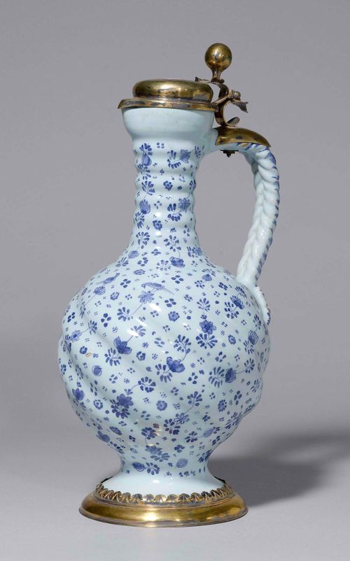 FAIENCE PITCHER WITH SILVER-GILT MOUNT, Hanau ca. 1700, silver-gilt mount Nuremberg, maker's mark: IHM. H 38 cm. Small hairline crack. Provenance: German private collection.