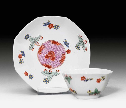 RARE OCTAGONAL CUP AND SAUCER, Meissen, ca. 1730. Painted in the Kakiemon style. Incised mark / (saucer), inventory number of the Japanese Palace 'N=352-W', incised and blackened on both parts. D saucer 12.9 cm, H cup 4.5 cm. 1 small chip on edge. Provenance: - Royal Saxon Collections, Japanese Palace, Dresden. - Collection Dr. Meyer-Werthemann, Zurich.
