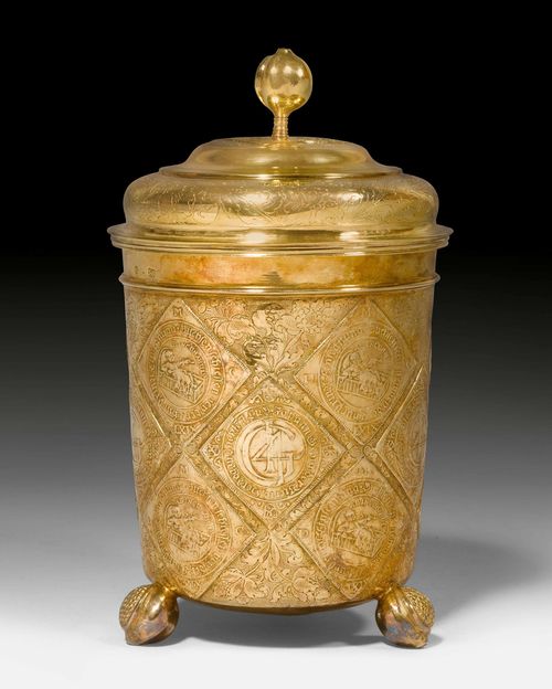 SILVER-GILT, LIDDED BEAKER,Dresden, last third of the 17th century. Maker&#39;s mark Johann Siegmund Bohrisch. Conical design with chiselled walls. Decorated with Saxon coins all around. On three pomegranate feet. Matching lid with pomegranate finial. Gilding, later. H 24 cm, 1229 g. Provenance: - Dr. Christoph Bernoulli (1897-1981), Basel. - from then on up until now in a Swiss private collection.