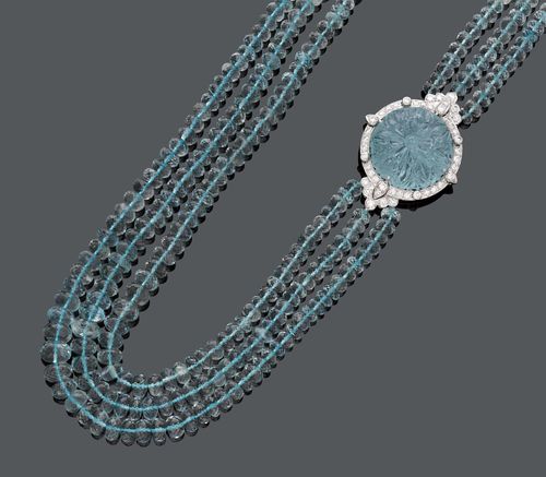AQUAMARINE DIAMOND NECKLACE. White gold 750, 116g. A 3 row aquamarine beads necklace, of ca. 5- 9,4 mm Ø, decorated with a flower motive set with a round aquamarine of 50.02 ct, within a diamond surround of ca. 2.50 ct. L ca. 58 cm.