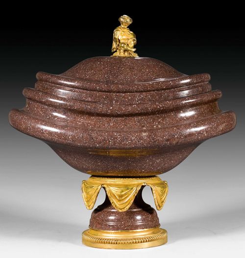 PORPHYRY BOWL AND COVER "A L'ENFANT",known as a "navette", Empire style, probably Rome. Porphyry with matte and polished gilt bronze. H 57 cm, W 55 cm.