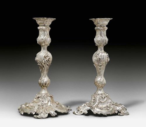 PAIR OF CANDLE HOLDERS, Louis XV style. Probably 18th century. Cast and chased. With incised inventory numbers and crowned "K". H 30 cm, total weight: 2600g. Provenance: German private collection.