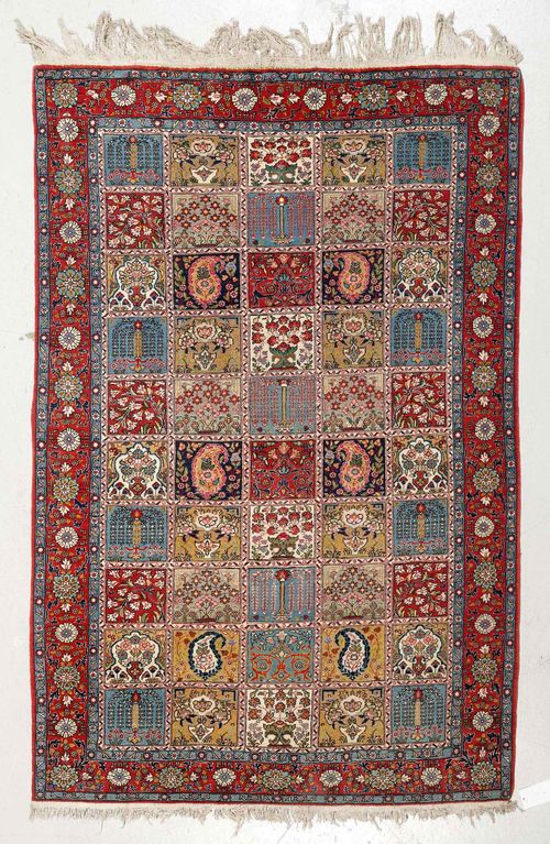 GHOM GARDEN CARPET. Central field patterned with plant motifs, red border with stylised tendrils, 140x204 cm.