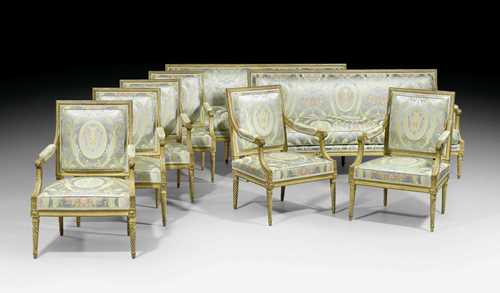 LARGE SUITE OF FURNITURE, Louis XVI, attributed to J.B.C. SENE (Jean-Baptiste Claude Sene, maitre 1769), Paris circa 1775/80. Comprising: 2 similar three-seater canapes and 6 large fauteuils "a la reine". Fluted and exceptionally finely carved gilt beech. Polychrome silk cover with flowers and leaves. Seat cushion. Canapes approx. 190x75x48x97 cm. Fauteuils 68x55x44x97 cm. Provenance: - Formerly part of the collections of the "hotel particulier" of Jacques Bemberg, Paris. - La Vieille Fontaine, Lausanne. - West Swiss private collection