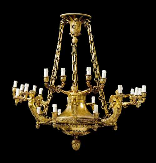 IMPORTANT CHANDELIER "AUX AMOURS", Empire, attributed to A.A. RAVRIO (André-Antoine Ravrio, 1759 Paris 1814), Paris ca. 1805/10. Matte and polished gilt bronze. Broad drip pans and vase-shaped nozzles. Chains, probably not original. Fitted for electricity. Some losses. D 100 cm. H 96 cm. Provenance: - from a French collection.