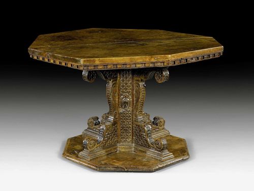 LIBRARY TABLE,Renaissance, Florence, 16th century. Exceptionally finely carved walnut with coat of arms, scaling, stylized rosettes, volutes and decorative frieze. Octagonal top. Some restoration required. D 134 cm. H 82 cm.