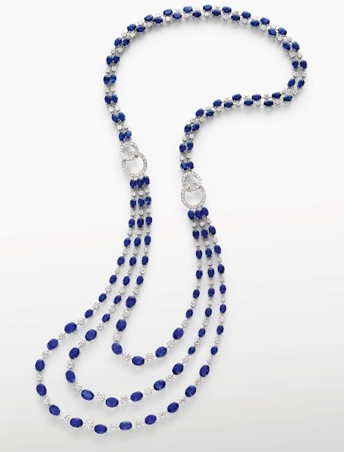 SAPPHIRE AND DIAMOND NECKLACE. White gold 750. A 2 row necklace, in Art-Déco style, alternated with 1 oval sapphire resp. 1 brilliant-cut diamond, joined to the 3 row front side through 2 interlocking diamond-set ring motifs. Total weight of sapphires ca. 88.70 ct and diamonds ca. 14.90 ct. L ca. 60 cm.