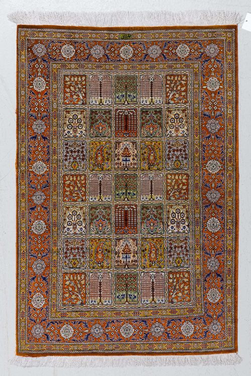 GHOM SILK, GARDEN CARPET.Colourful central field with plant motifs, rust coloured border, in good condition, 80x118cm.