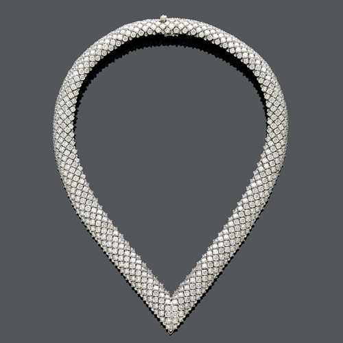 DIAMOND NECKLACE WITH BRACELET AND EARCLIPS,  BY ADLER. White gold 750. &quot;V&quot;-shaped necklace, set with brilliant-cut diamonds weighing ca. 62.56 ct, L ca. 41 cm. Matching bracelet, diamonds weighing ca. 31.55 ct, L ca. 18,5 cm and half hoop ear clips, diamonds weighing ca. 9.88 ct.