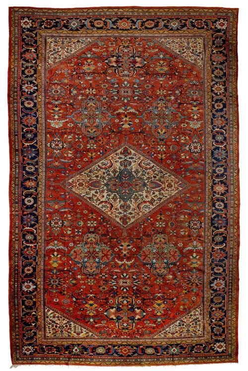MAHAL antique.Red ground with a central medallion, patterned with bulky trailing flowers and palmettes, dark blue border with stylised tendrils, 340x580cm.