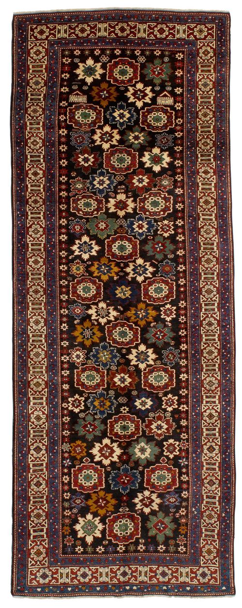 SHIRVAN old.Black central patterned throughout with star motifs, geometrically patterned red border, in good condition, 135x356cm.