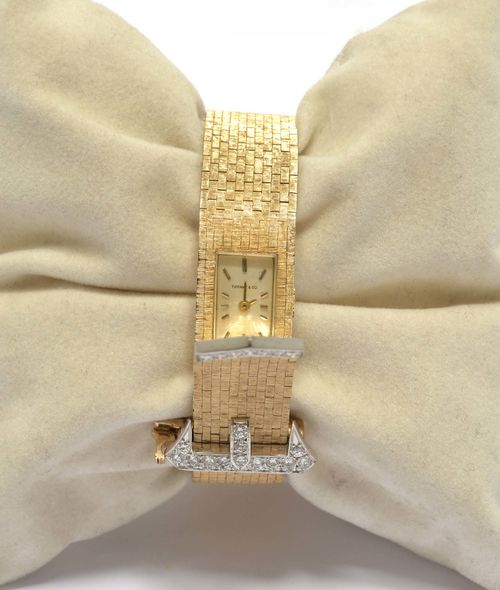 DIAMOND AND GOLD BRACELET WATCH, 1950s. Yellow gold 585, 45g. "À ceinture" model with hidden watch. Decorative, satin-finished brick-pattern bracelet, the clasp and end pavé-set with 28 brilliant-cut diamonds weighing ca. 0.50 ct. Rectangular case No. 11346 engraved C+B. Silver-coloured dial signed Tiffany & Co. with gold-coloured indices and hands. Form movement No. 489PH, Cal. FHF59-21 signed Concord Watch Co.