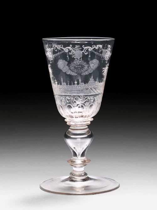 BAROQUE ARMORIAL GOBLET WITH A VEDUTA OF JERUSALEM,Bohemia, 18th century. Colorless glass. Cut and engraved with a city view of Jerusalem, the rim with a Baroque garland with coats of arms. H 22.8 cm.