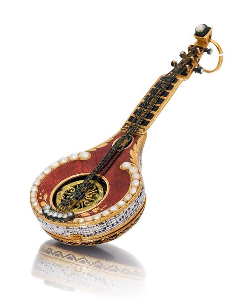 RARE CYLINDER WATCH WITH EXQUISITE ENAMEL WORK. Gold, enamel, and half-pearls. Case designed as a mandolin, engraved, red enamelled and set with half-pearls, the open centre with engraved skeleton balance bridge, the handle enamelled black, one lateral part missing. The back engraved and enamelled burgundy, sprung cover with small flower in gold with blue and green enamel. The side of the mandolin with a very fine enamel miniature depicting the notes of the aria by Nicolas-Medard Audinot (1732-1801) "Le Tonnelier" from the Comical Opera 1761 and the text: "un tonnelier vieux et jaloux" in black on a white ground. Enamelled dial with Arabic numerals, pink gold hands, and winder at 2h. Miniature cylinder movement with skeleton bridge and small regulator scale, fusee and chain. Enamel, in part restored. D 64 x 26 mm.