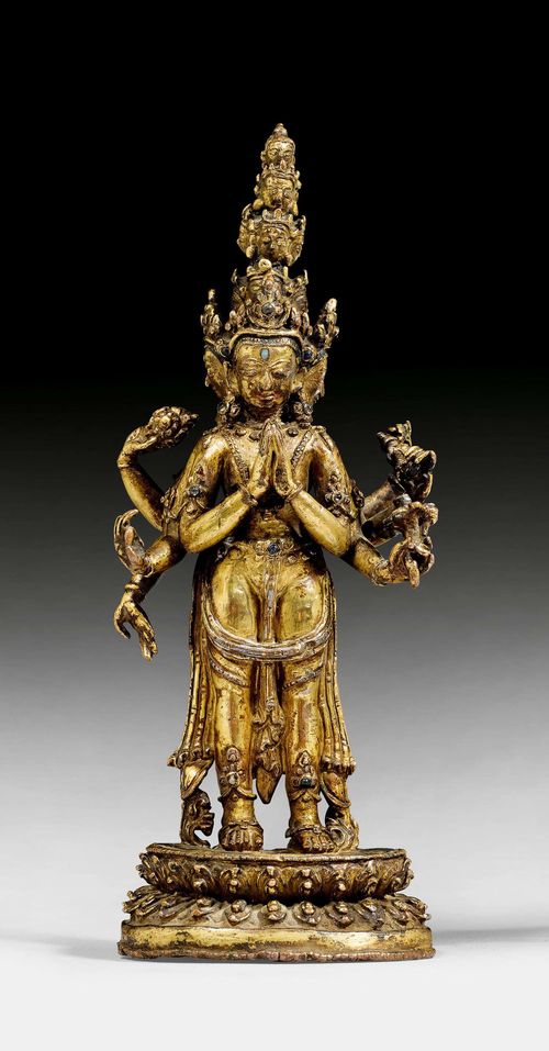 A GILT COPPER ALLOY FIGURE OF THE ELEVEN-HEADED AVALOKITESHVARA. Nepal, 16th c. height 21 cm. Consecration plate lost.