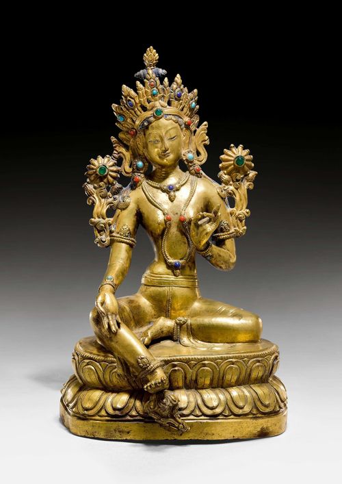 A GILT COPPER ALLOY FIGURE OF THE GREEN TARA WITH COLOURFUL INLAYS. Eastern Tibet, 18th/19th c. Height 23.5 cm.