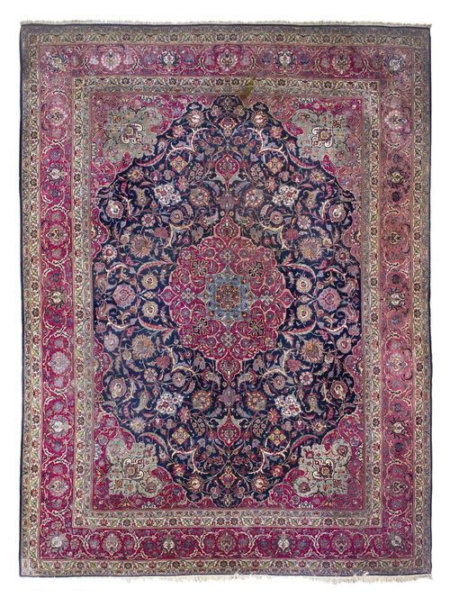 TABRIZ old.Dark blue ground with a red central medallion and green and red corner motifs, the entire carpet is finely patterned with trailing flowers and palmettes, red border, signs of wear, 420x315 cm.