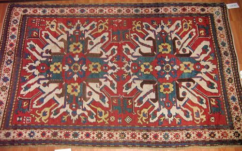 CHELABERD antique.Red ground with two eagle motifs in white, green and red, white border, signs of wear, 212x135 cm.