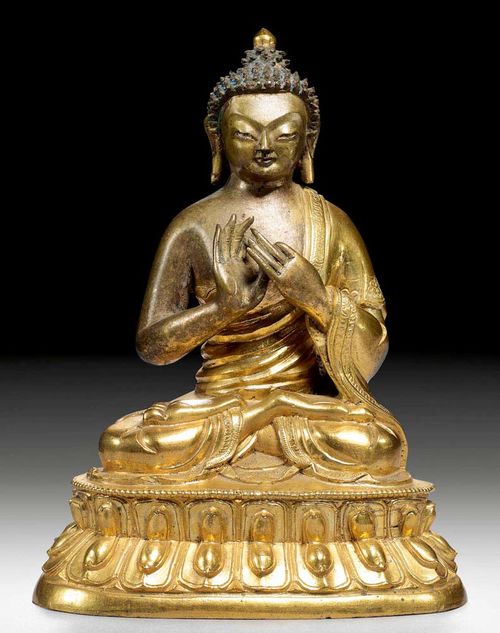 VAIROCANA.Sino-Tibetan, 18/19th century  H 16 cm. Parcel-gilt bronze with remains of old painting in the hair. With finely engraved garment edges. Plinth missing.