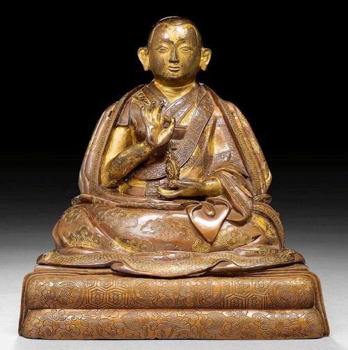 THE 9TH DALAI LAMA.Tibet, 19th century  H 17.5 cm. Parcel gilt copper alloy. The garments adn the cushion are decorated with engraving. Two small holes on the shoulders point to two missing lotus flowers. Identified by the inscription verso.