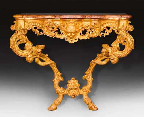 IMPORTANT CONSOLE "AUX DRAGONS",Regence, probably after designs by N. PINEAU (Nicolas Pinau, 1684-1754), attributed to J.B.H. TORO (Jean Bernard Honore Turreau, called Toro, 1672-1731), Paris circa 1730. Pierced and exceptionally finely carved gilt wood. Shaped "Breche Rose" top. 114x55x100 cm.