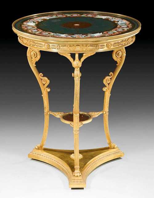 IMPERIAL ROUND GUÉRIDON "AUX CYGNES" WITH "VERRE EGLOMISE" TOP,Empire, from a Paris master workshop , circa 1810. Matte and polished gilt bronze support with swan motifs and paw feet, the top with exceptionally fine behind-glass painting depicting golden rosettes, palmettes and frieze against an emerald green ground in a polychrome frame with swans and foliate work. With exceptionally fine bronze applications. D 64 cm, H 77 cm. Provenance: private collection, Monaco