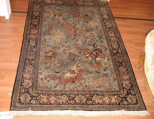 GHOM silk old.Turquoise central field depicting a hunting scene, dark border with floral cartouches, good condition, 105x165 cm.