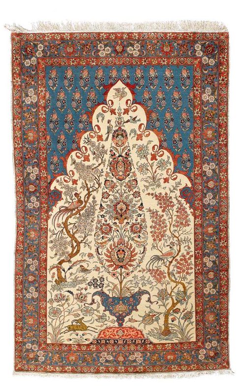 THERAN antique.Very attractive collector's item in very good condition. Beige mihrab with three trees of life, animals and blossoms in attractive pastel colours, blue spandrels with small flowers, triple stepped border in dusky pink and blue, also florally decorated, , 220x140 cm.