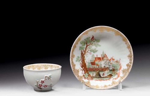 CUP AND SAUCER WITH HAUSMALER DECORATION, Meissen, workshop of Franz Ferdinand Mayer in Pressnitz, circa 1750. The saucer painted with a village scene inside and decorated with fluting on the outside, the cup with Indianische Blumen inside and prunus branches in relief heightened in iron red, sea green and brown. Each with gilding. Underglaze blue sword marks, impressed number  2 on the cup. Not matching. The colours and gilding somewhat rubbed. Provenance: - collection of Paul, Riehen-Basel. - private collection, Switzerland