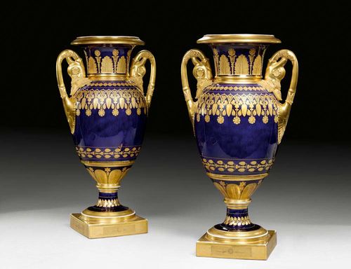 FINE PAIR OF EMPIRE VASES 'FOND BLEU LAPIS', Paris, circa 1810.With gilt acanthus leaf handles with dolphin heads and gold decoration of continuous arabesque border on a lapis lazuli ground. H 37cm.