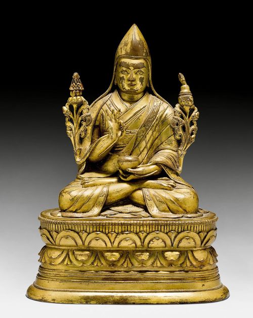 A GILT COPPER ALLOY FIGURE OF A HIGH RANKING MONK. Mongolia, 18th c. Height 20.5 cm. Vajra and consecration plate replaced.