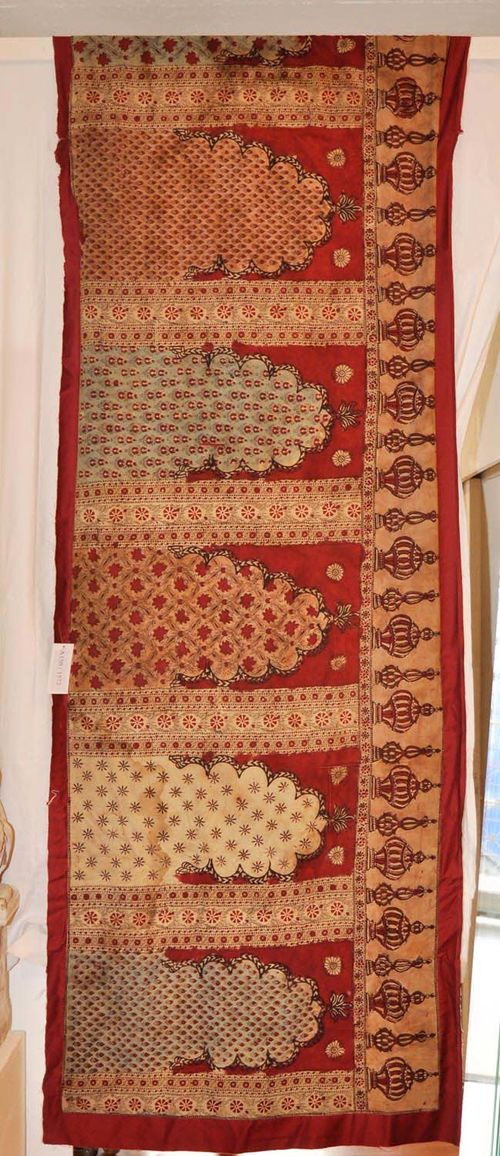 QALAMKAR INDIA antique.Nine prayer niches on a red ground. The nine mihrabs in beige, turquoise and white, patterned with floral motifs, Upper frieze decorated with lanterns. Stained, 90x460 cm.