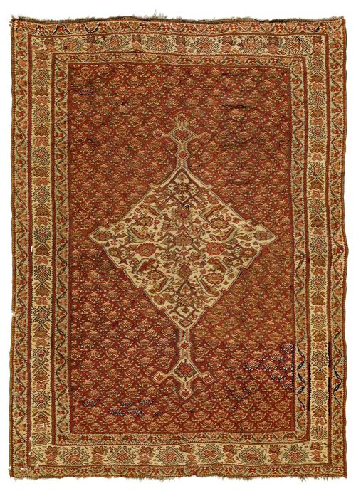 SENNEH KILIM antique.Rust coloured ground with a white central medallion, finely patterned with floral motifs in delicate pastel colours, white border, small areas to be restored, 136x179 cm.