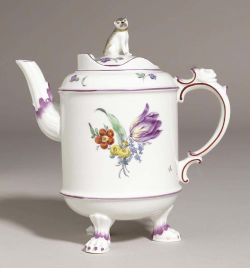 COFFEE POT ON CLAW FEET, LUDWIGSBURG, CIRCA 1770.Cylindrical form with rocaille handle crowned with a lion's head, the lid with pug dog as finial, painted with floral bouquets. Crowned CC monogram mark in underglaze blue. H 20cm. The dog's tail broken. Provenance: - Private collection, Hamburg. - Via inheritance to a private collection in South Germany