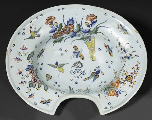 FAIENCE SHAVING BOWL, FRANCE, PROBABLY SINCENY 18TH CENTURY.Painted in oriental style with vase of carnations, cherry blossom and peach blossom, insects, birds and small rosettes, with LA monogram in the centre. No mark. D 35cm. Minor chip to edge