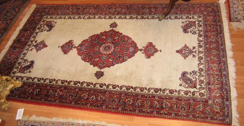 BACHTIAR old.White ground with a red central medallion, red edging with trailing flowers, good condition, 160x252 cm.