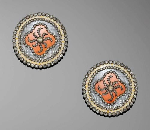 PAIR OF ENAMEL AND DIAMOND CLIP/BROOCHES, probably Russia ca. 1890. Yellow gold 750 and silver. Very attractive, large round clip/brooches, centre with orange translucid enamel on a guilloche-decorated background, decorated with an appliquéd eight-ray flower motif set with diamonds and a diamond frame, surrounded by light blue, translucid enamel on a guilloche-decorated background, in a round diamond frame with an ivory-coloured enamel rim with floral gold painting and an additional diamond frame at the end. In total: ca. 121 rose-cut diamonds totalling ca. 0.70 ct. Ø ca. 3.85 cm. French import marks. With case.