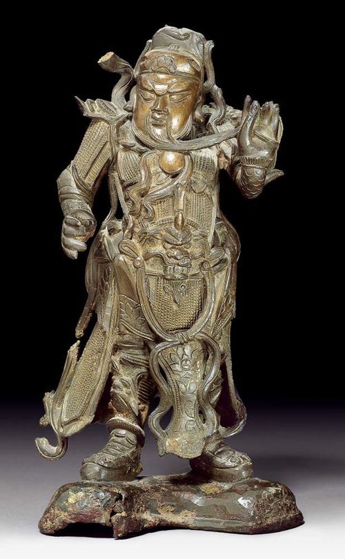 GUAN DI.China, Ming Dynasty, H 29 cm. Bronze. Vivid depiction of the general in full armour stroking his beard while frowning. Damaged scarf.