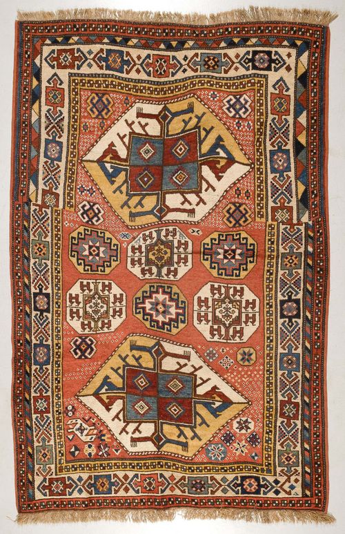 KARAKALPA antique.Dusky pink ground with two large and six small medallions. The entire carpet is geometrically patterned with star-shaped motifs, white border, good condition, 165x250 cm.