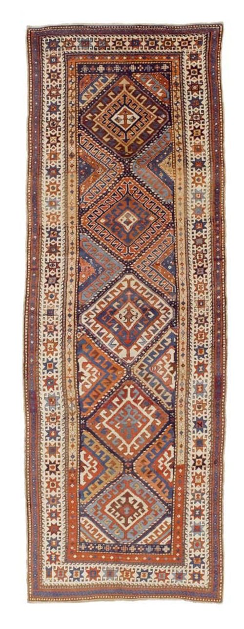 BORTSHALU antique.Honeycomb patterned central field with hooked rhombus motifs in bright colours. White border. Good condition, 340x110 cm.