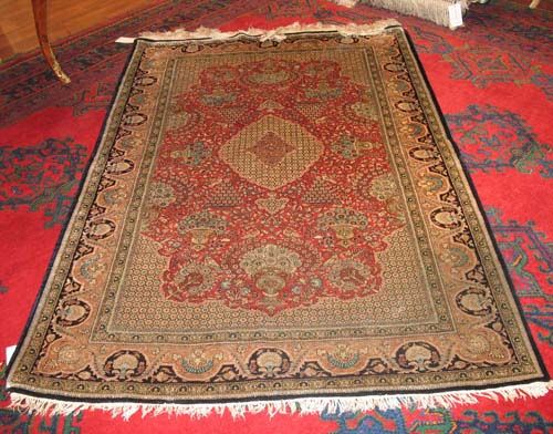 GHOM SILK RUG old.Rust red central field with light central medallion and corner motifs, finely patterned with vases of flowers in light blue tones. Beige border. Good condition, 220x137 cm.