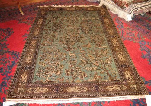 GHOM SILK RUG old.Turquoise central field decorated with trees and animals in white. Yellow border. Good condition, 215x140 cm.
