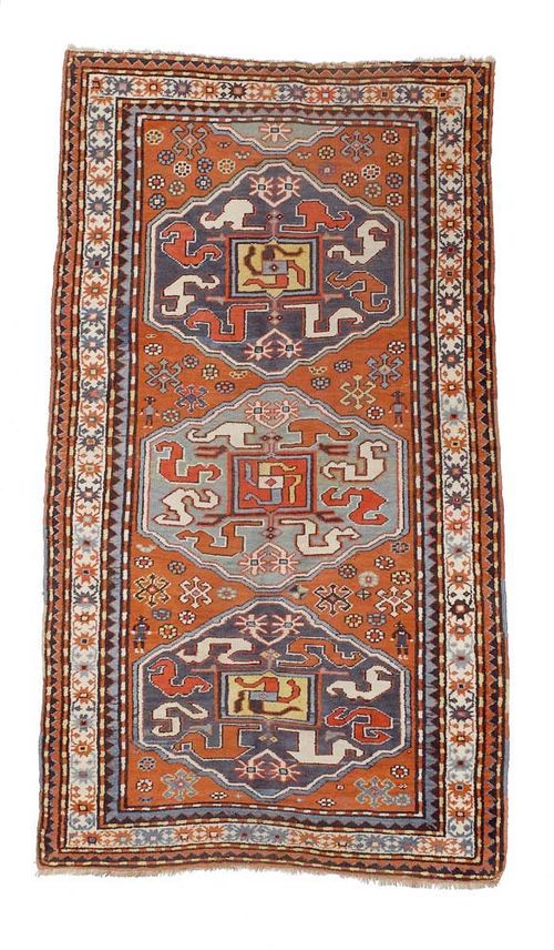 KAZAK old.Three medallions with cloud band motifs on red ground. Slight wear. 225x130 cm.