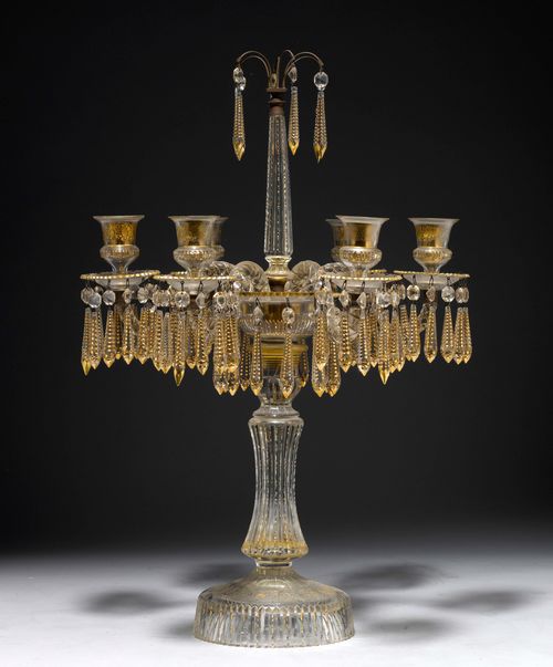CANDELABRA,England, 19th century. Crystal glass, parcel-gilt. Ribbed, retracted shaft. 6 light branches with round drip plates and cylindrical nozzles. On a round foot. H 65 cm. Provenance: Gut Aabach, Risch am Zugersee.