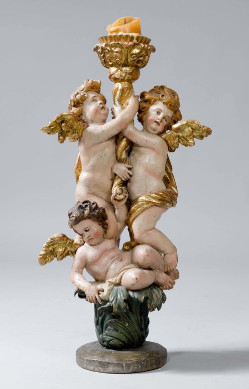 CANDLESTICK WITH FIGURES,in the Baroque style. Wood, carved and painted. Shaft with 3 angels, cornucopia-like candle holder. H 83 cm. Provenance: Gut Aabach, Risch am Zugersee.