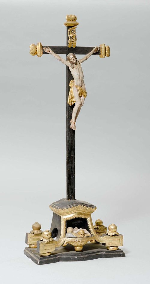 STANDING CROSS, Bizau, circa 1800. Carved and painted wood. At the base: the sleeping Infant Jesus. H 64 cm.